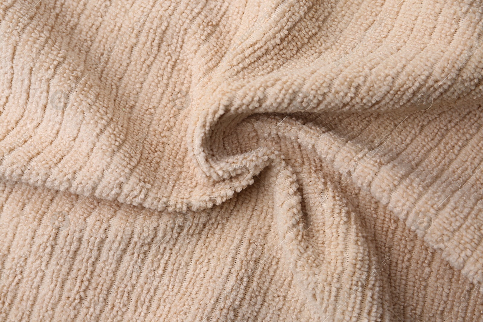 Photo of Clean beige microfiber cloth as background, top view