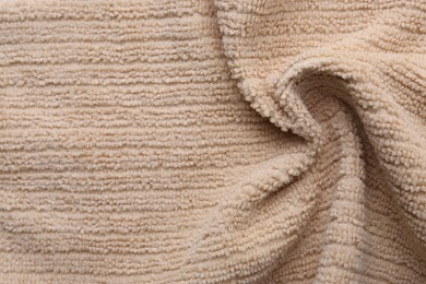 Photo of Clean beige microfiber cloth as background, top view