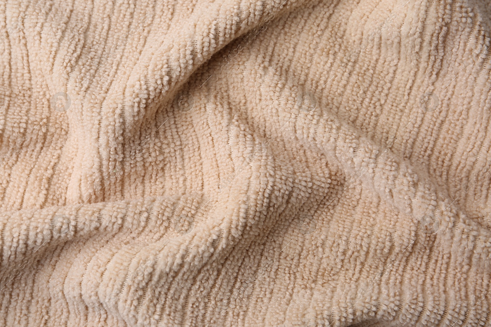 Photo of Clean beige microfiber cloth as background, top view