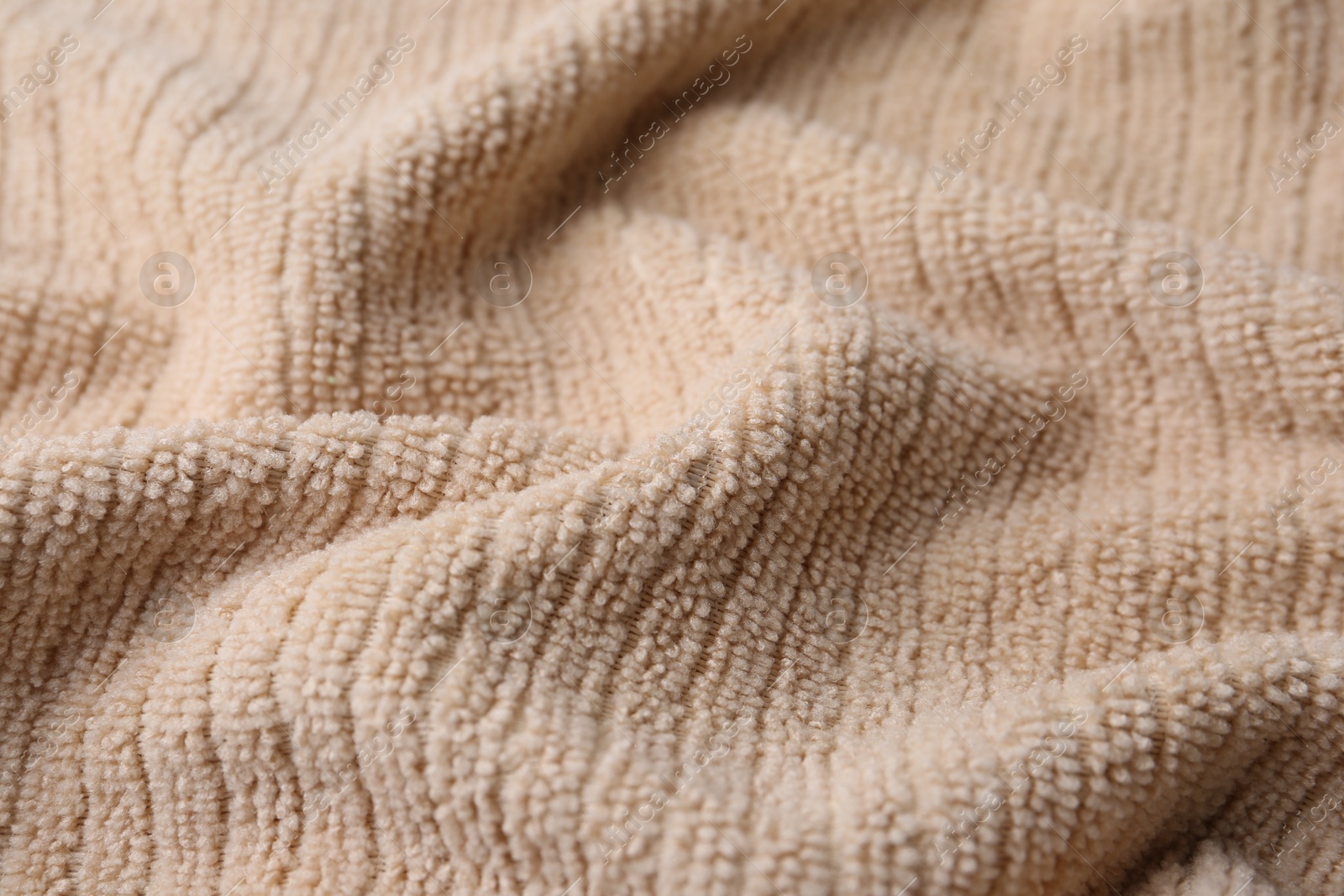 Photo of Clean beige microfiber cloth as background, closeup