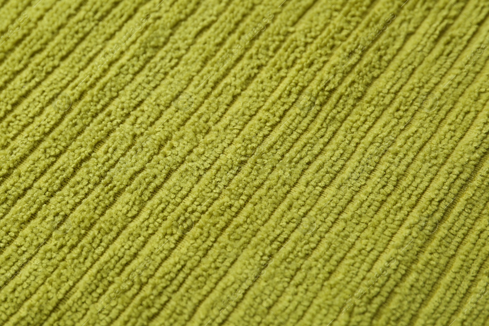 Photo of Clean green microfiber cloth as background, closeup