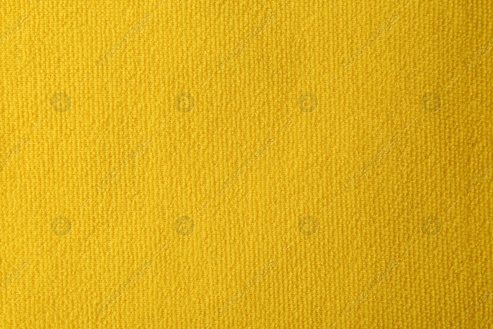 Photo of Clean yellow microfiber cloth as background, top view