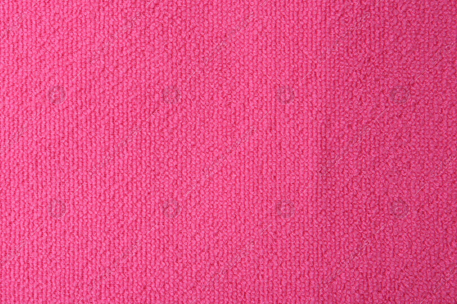 Photo of Clean pink microfiber cloth as background, top view