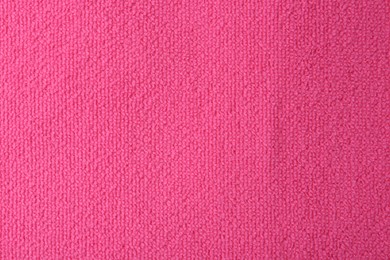 Photo of Clean pink microfiber cloth as background, top view