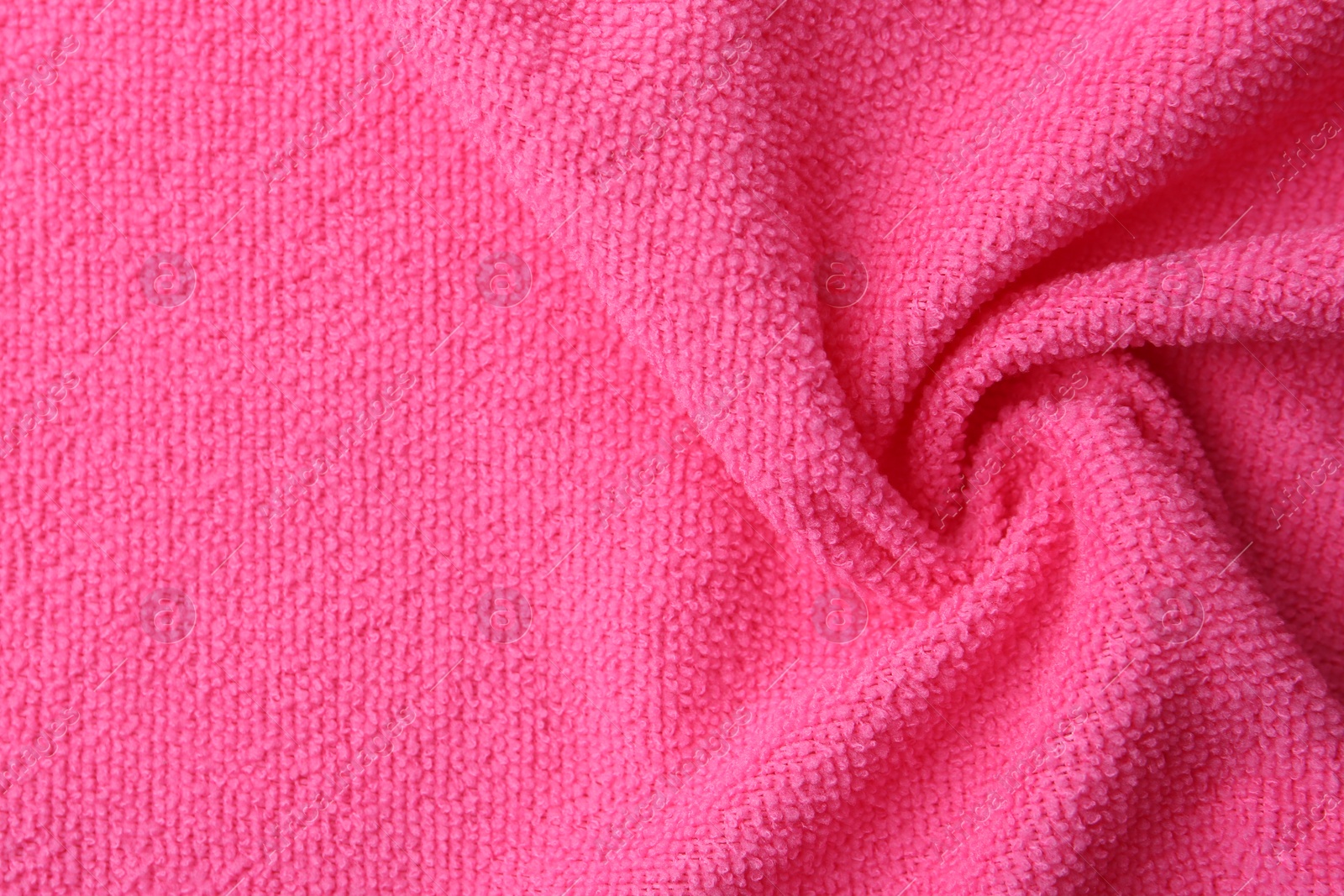 Photo of Clean pink microfiber cloth as background, top view