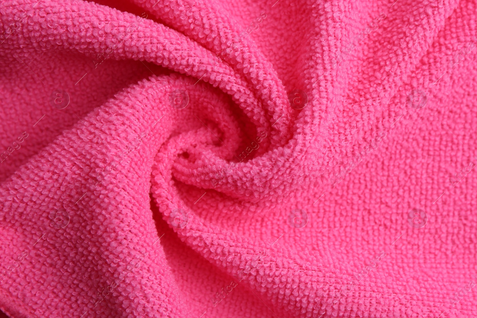 Photo of Clean pink microfiber cloth as background, top view