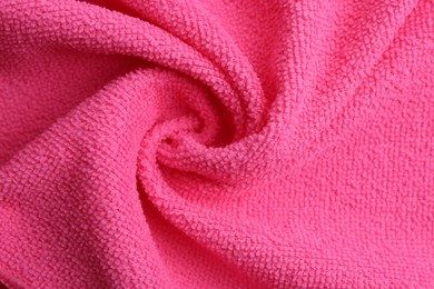 Clean pink microfiber cloth as background, top view