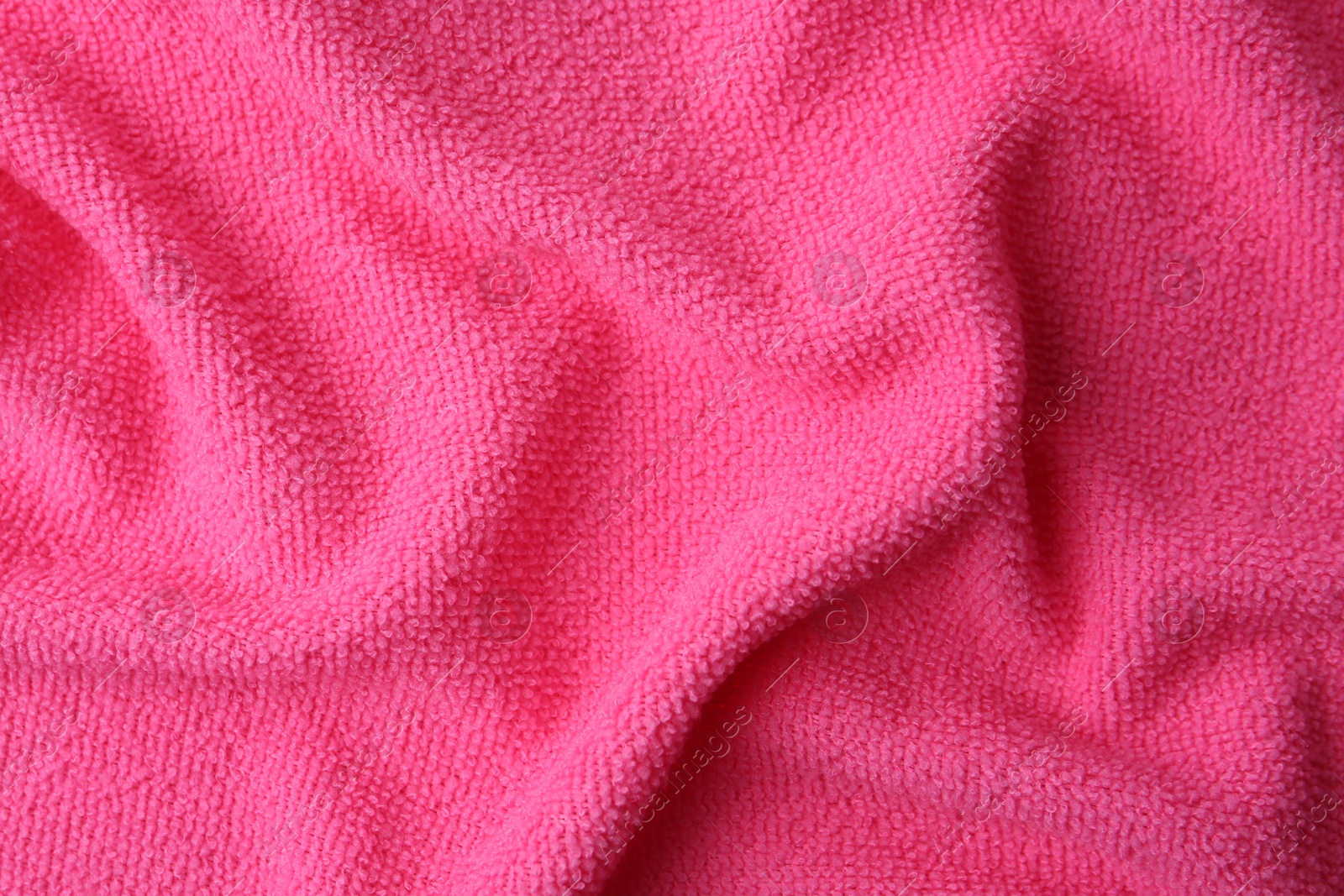 Photo of Clean pink microfiber cloth as background, top view