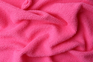 Photo of Clean pink microfiber cloth as background, top view