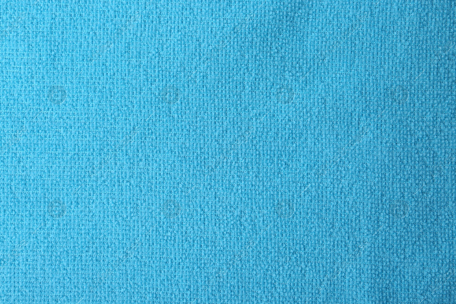 Photo of Clean light blue microfiber cloth as background, top view