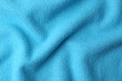 Clean light blue microfiber cloth as background, top view