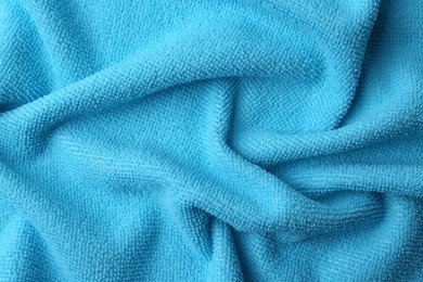 Clean light blue microfiber cloth as background, top view