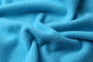 Clean light blue microfiber cloth as background, closeup