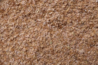 Pile of buckwheat bran as background, top view