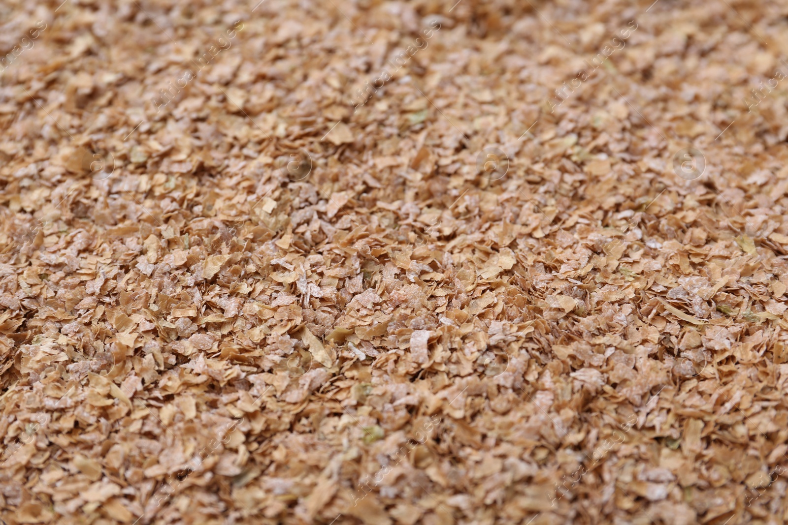 Photo of Pile of buckwheat bran as background, closeup