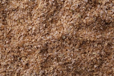 Photo of Pile of buckwheat bran as background, top view