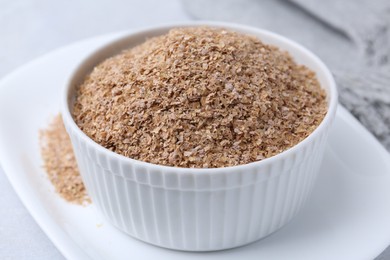 Buckwheat bran in bowl on table, closeup