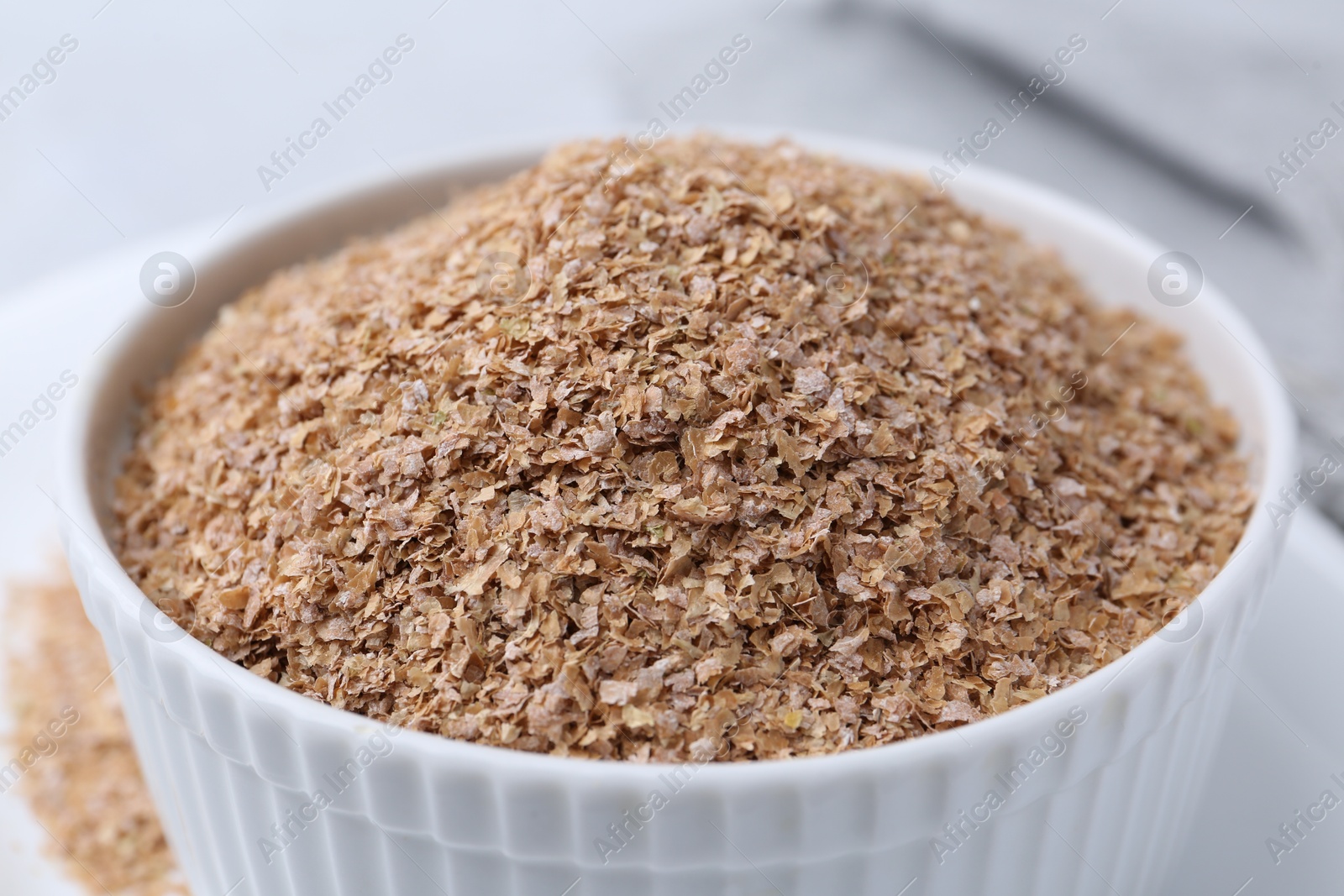 Photo of Buckwheat bran in bowl on table, closeup