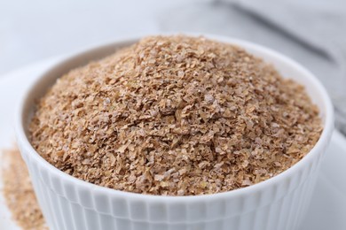 Buckwheat bran in bowl on table, closeup