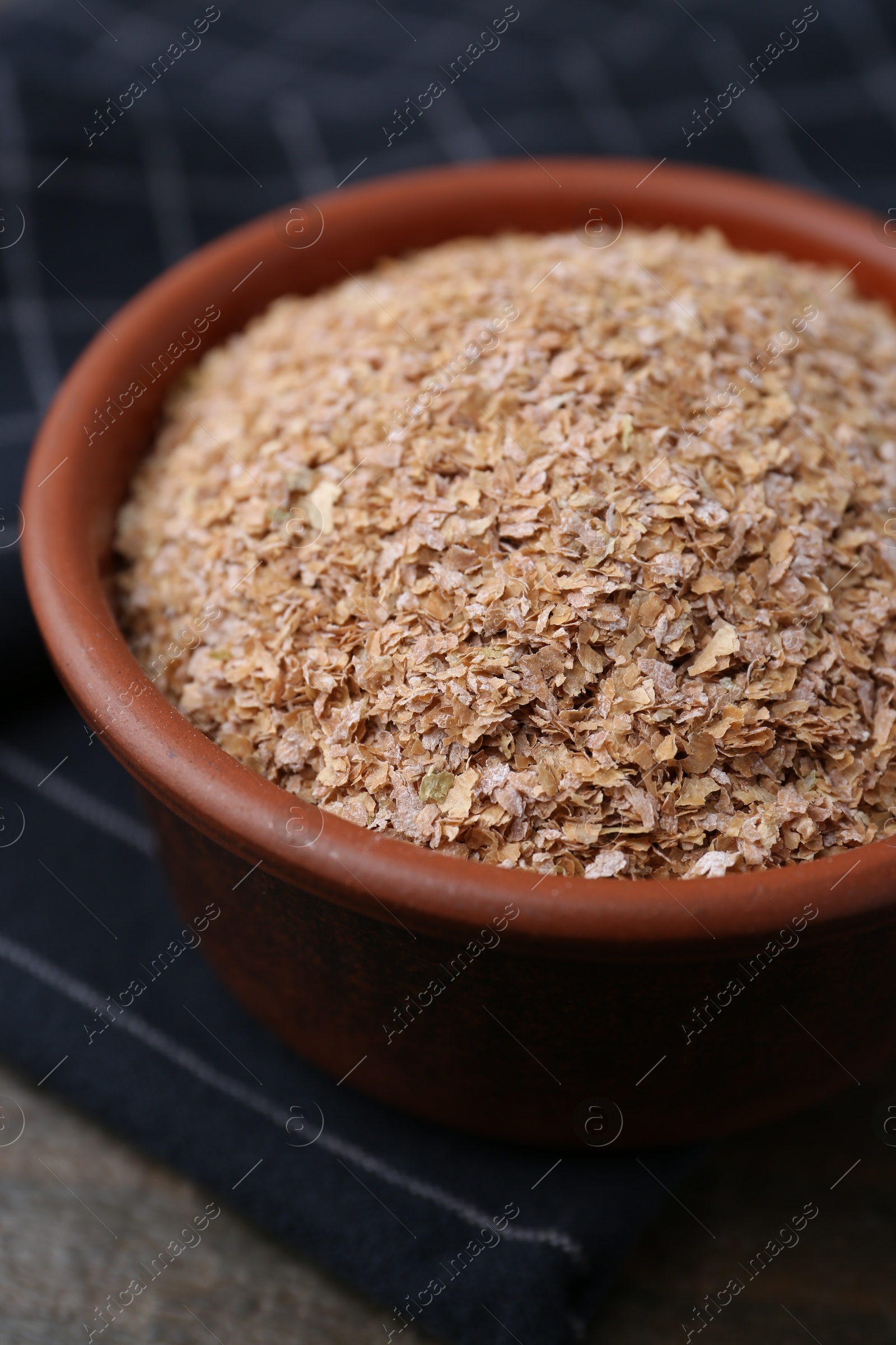 Photo of Buckwheat bran in bowl on table, closeup