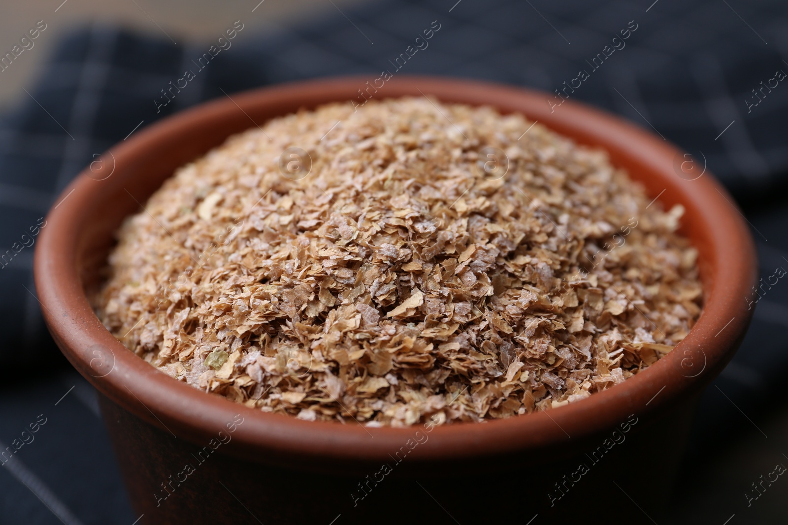 Photo of Buckwheat bran in bowl on table, closeup