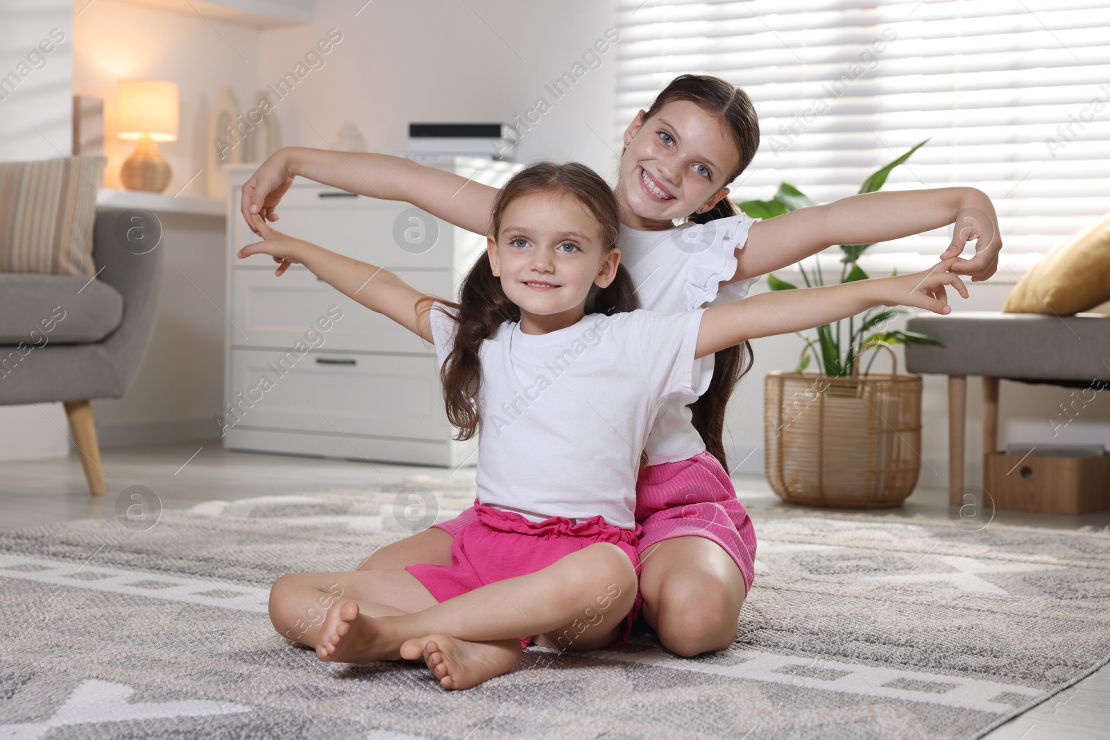 Photo of Portrait of cute little sisters at home