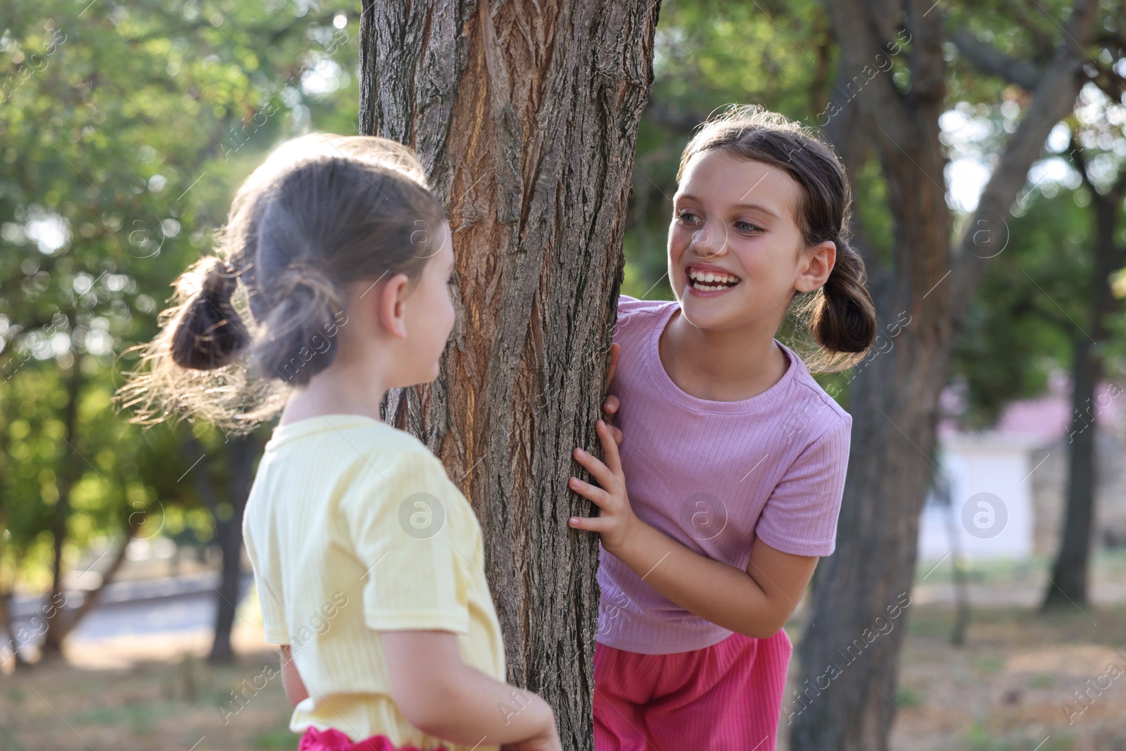 Photo of Cute little sisters spending time together in park