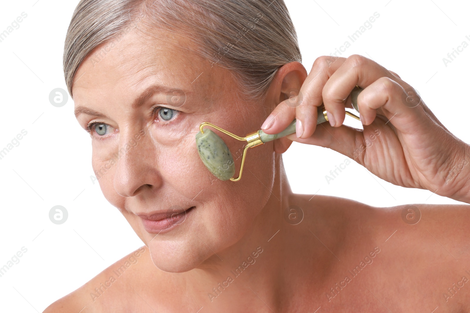 Photo of Beautiful woman doing facial massage with roller on white background