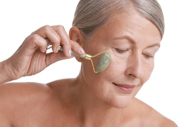 Photo of Beautiful woman doing facial massage with roller on white background