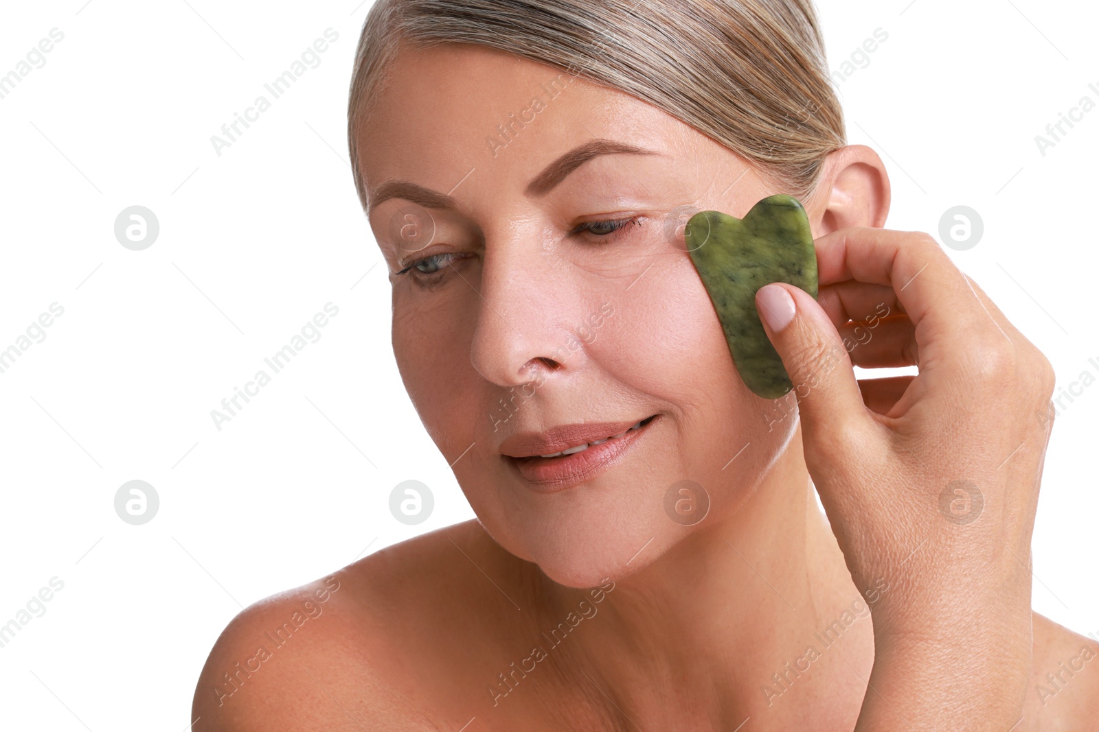 Photo of Beautiful woman doing facial massage with gua sha tool on white background