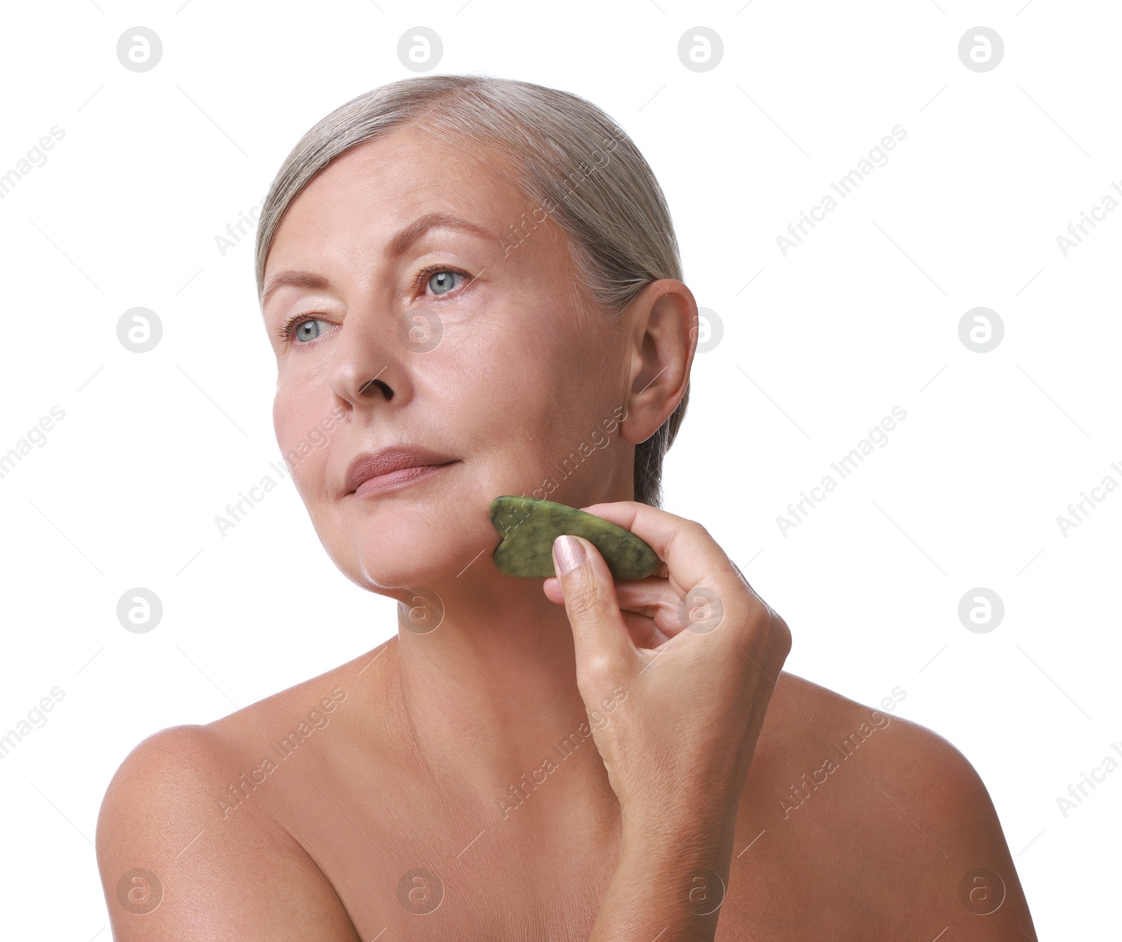 Photo of Beautiful woman doing facial massage with gua sha tool on white background