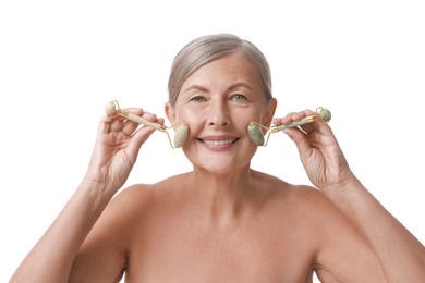 Photo of Beautiful woman doing facial massage with rollers on white background