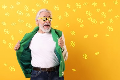 Image of Excited man with sunglasses on yellow background. Percent signs on lenses. Discount, hot offer