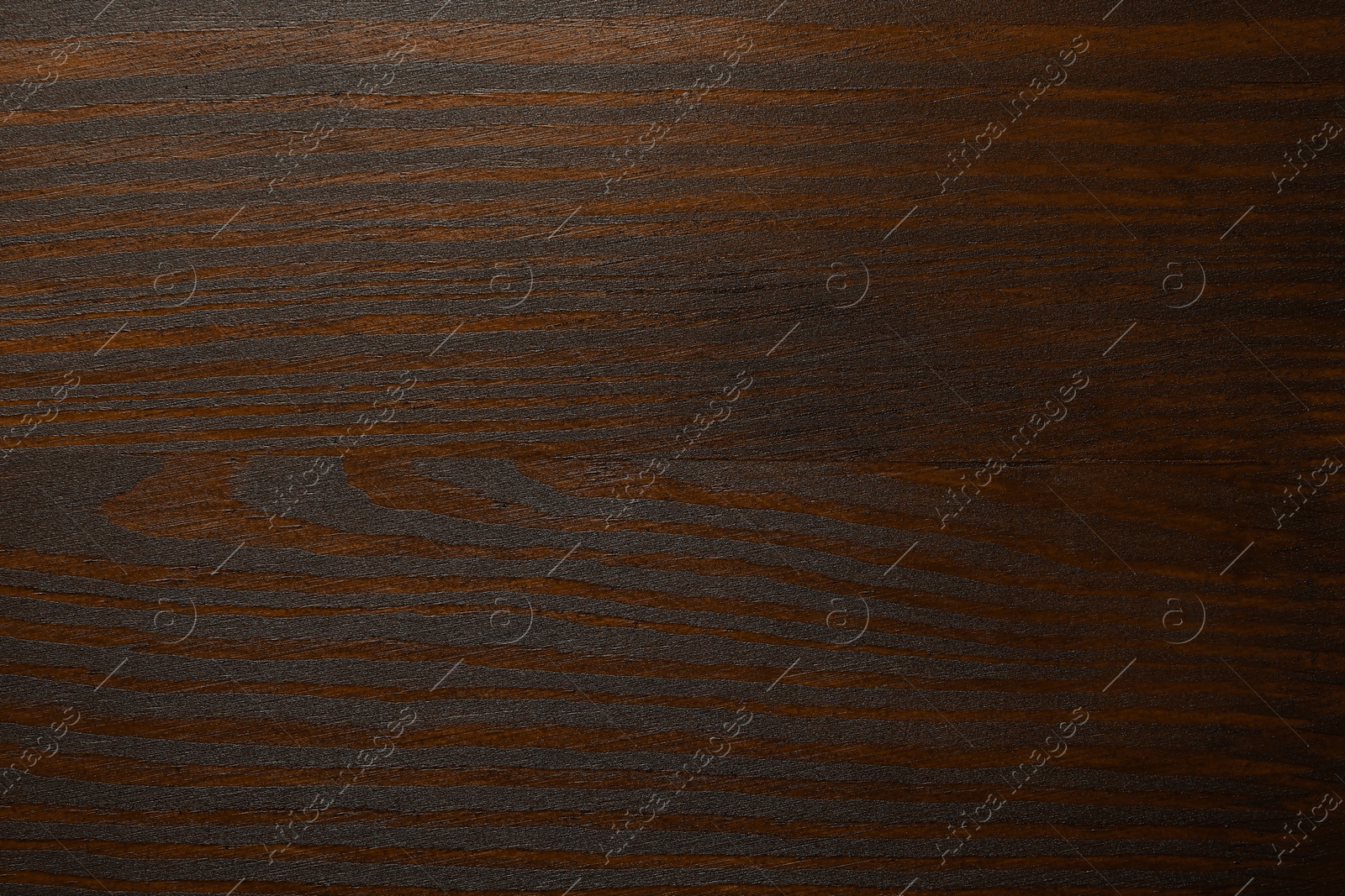 Photo of Texture of wooden surface after applying walnut wood stain as background, top view