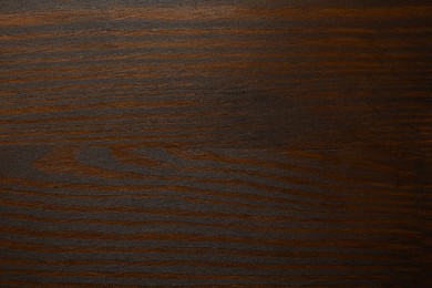 Photo of Texture of wooden surface after applying walnut wood stain as background, top view