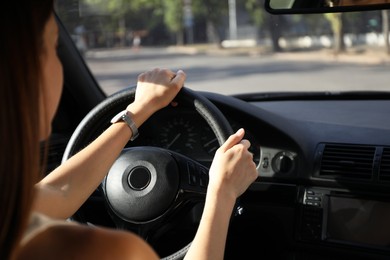 Photo of Woman holding steering wheel while driving car, closeup