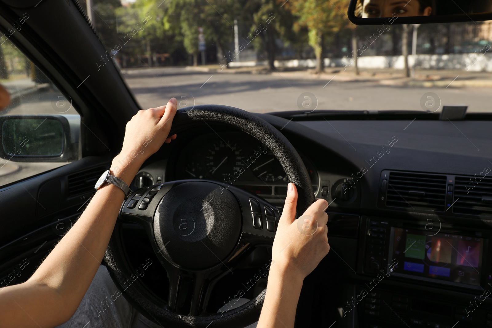 Photo of Woman holding steering wheel while driving car, closeup