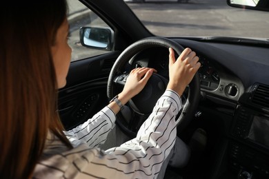 Woman holding steering wheel while driving car