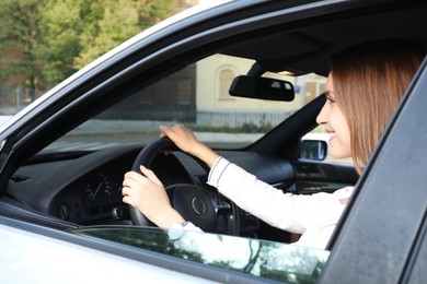 Photo of Woman holding steering wheel while driving car