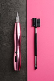 Professional permanent makeup machine and brush on color background, flat lay