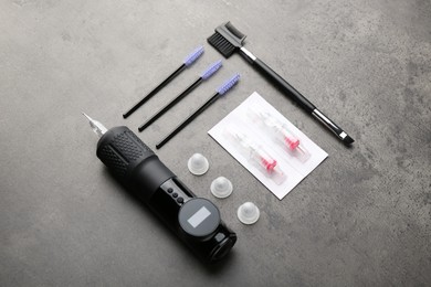 Photo of Permanent makeup equipment kit on grey table