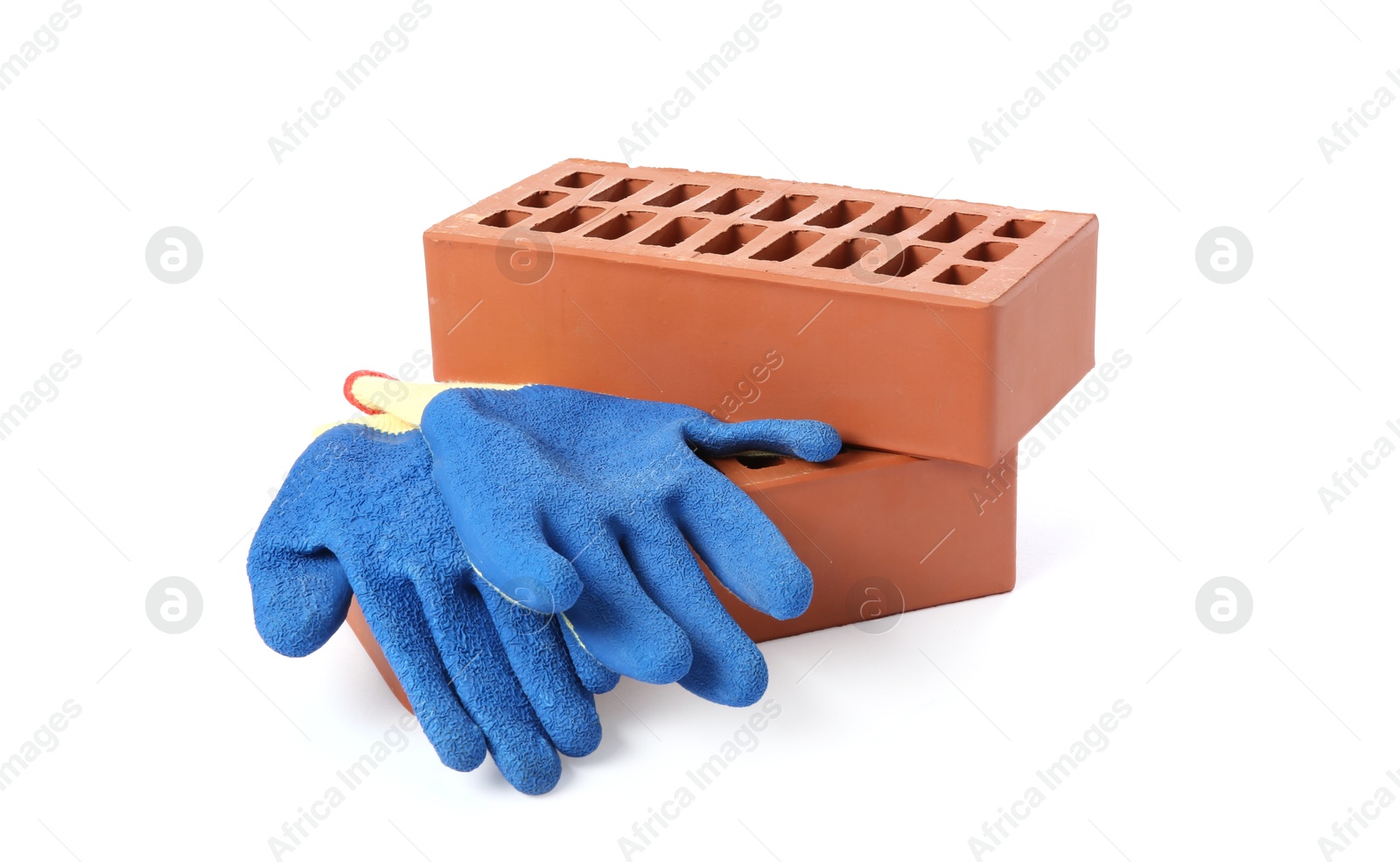 Photo of Red bricks and gloves on white background