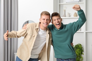 Photo of Family portrait of emotional brothers at home