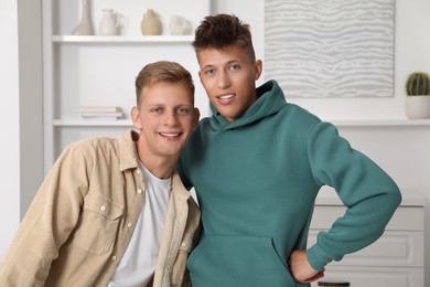 Photo of Family portrait of happy brothers at home