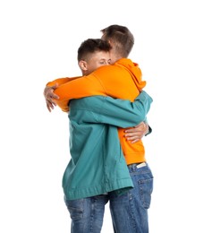 Two young brothers hugging on white background