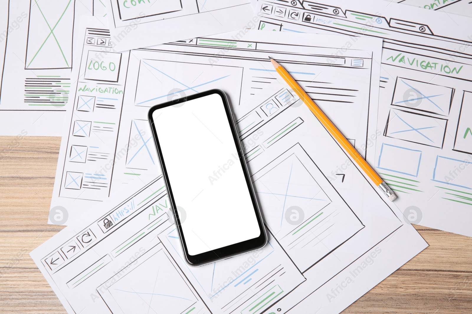 Photo of Website development. Sketches of wireframes, smartphone and pencil on wooden table, flat lay