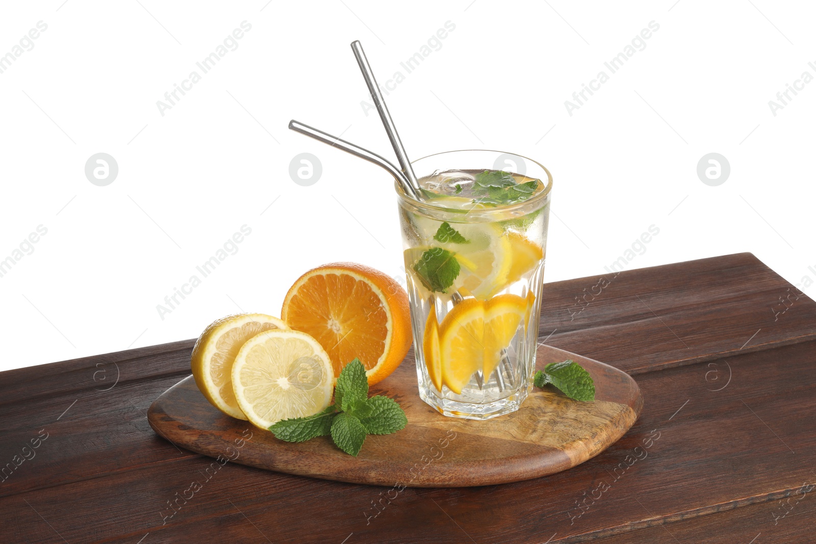 Photo of Glass of tasty refreshing drink with straws and fresh fruits on wooden table against white background