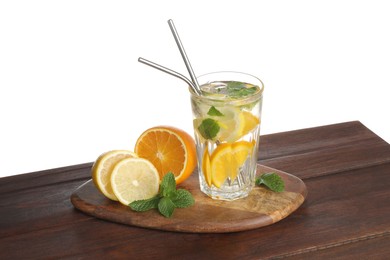 Photo of Glass of tasty refreshing drink with straws and fresh fruits on wooden table against white background