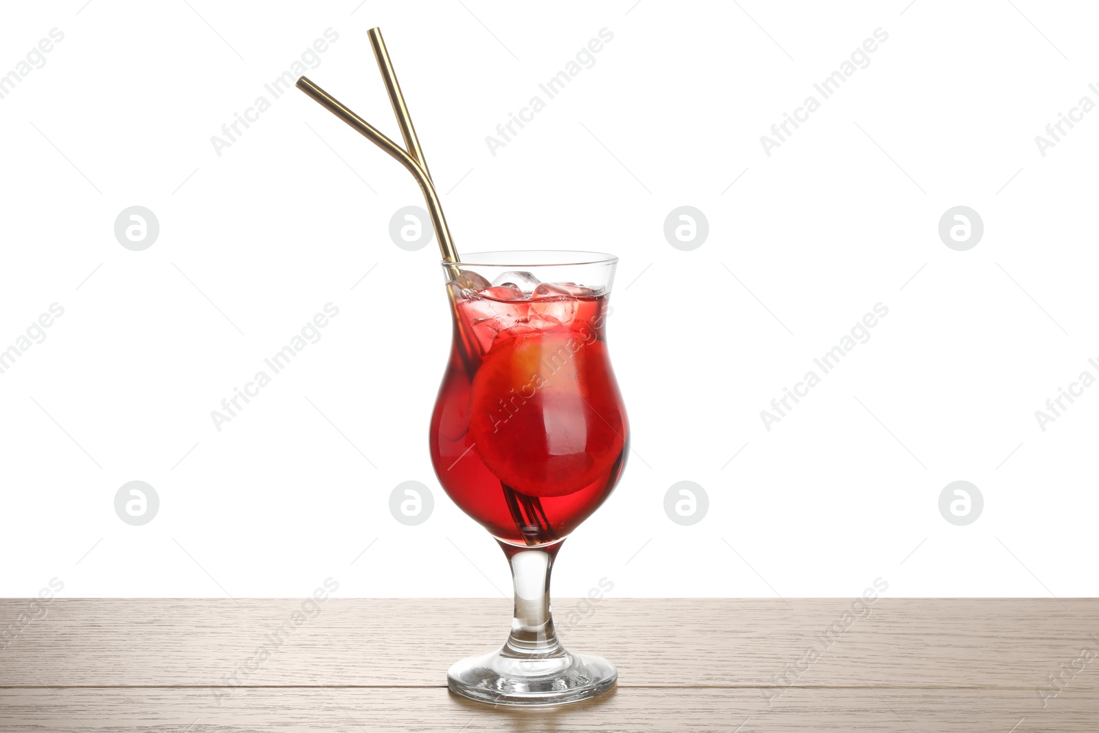 Photo of Glass of tasty refreshing drink and straws on wooden table against white background