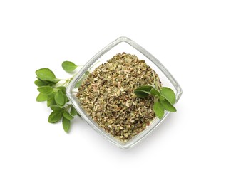 Photo of Dried oregano in glass bowl and green leaves isolated on white, top view